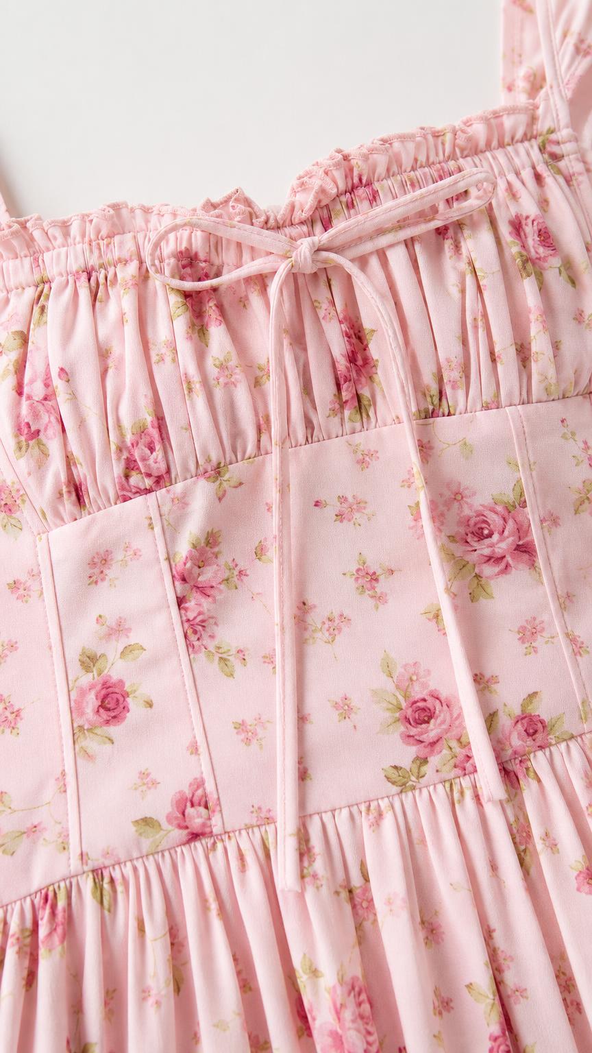 Close-up of pink floral dress bodice and tie detail